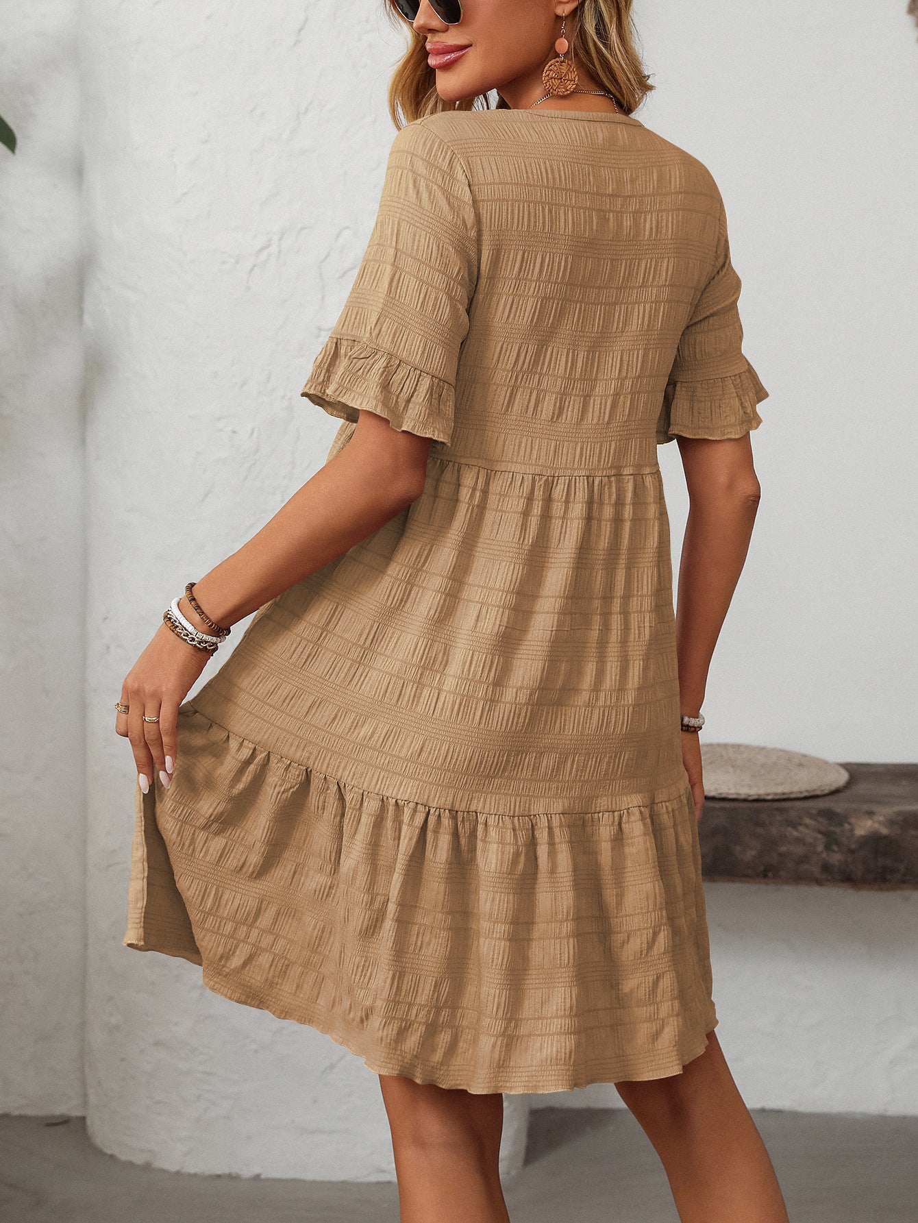 Melba Lane – Studland tan textured tiered short-sleeve dress, front view of the tiered hem with hands at the sides, AU women's sizes