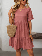 Melba Lane – Studland dusty rose textured tiered short-sleeve dress, front view with a straw tote on the forearm, AU women's sizes