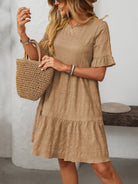 Melba Lane – Studland tan textured tiered short-sleeve dress, front view holding a straw tote at shoulder height, AU women's sizes