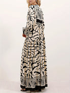 Melba Lane – cream and black print maxi dress worn with a clutch bag, AU women's sizes