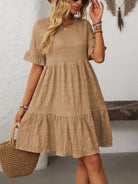 Melba Lane – Studland tan textured tiered short-sleeve dress, front view with a straw tote on the arm, AU women's sizes