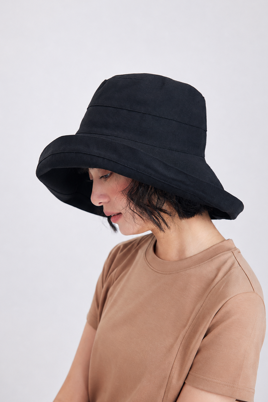 Melba Lane – Tossa black wide-brim foldable sun hat in side profile, showing the deep downward brim