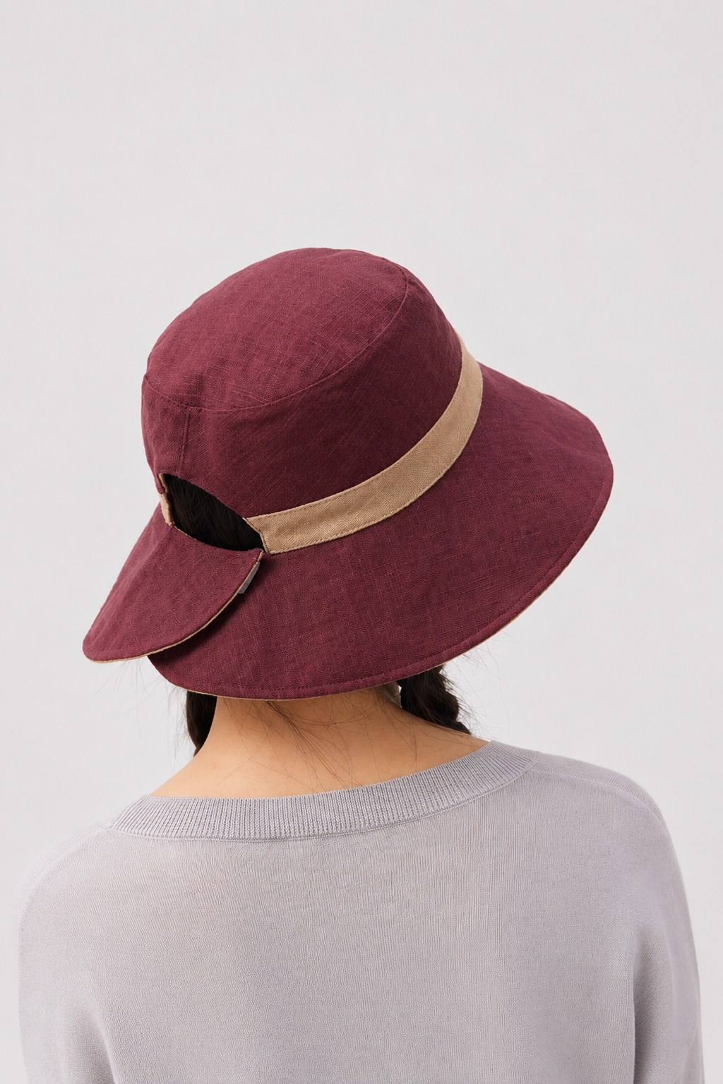Melba Lane – Tinos reversible sun hat turned to its burgundy side with a tan band, back view showing the adjustable tab