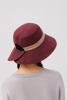 Melba Lane – Tinos reversible sun hat turned to its burgundy side with a tan band, back view showing the adjustable tab