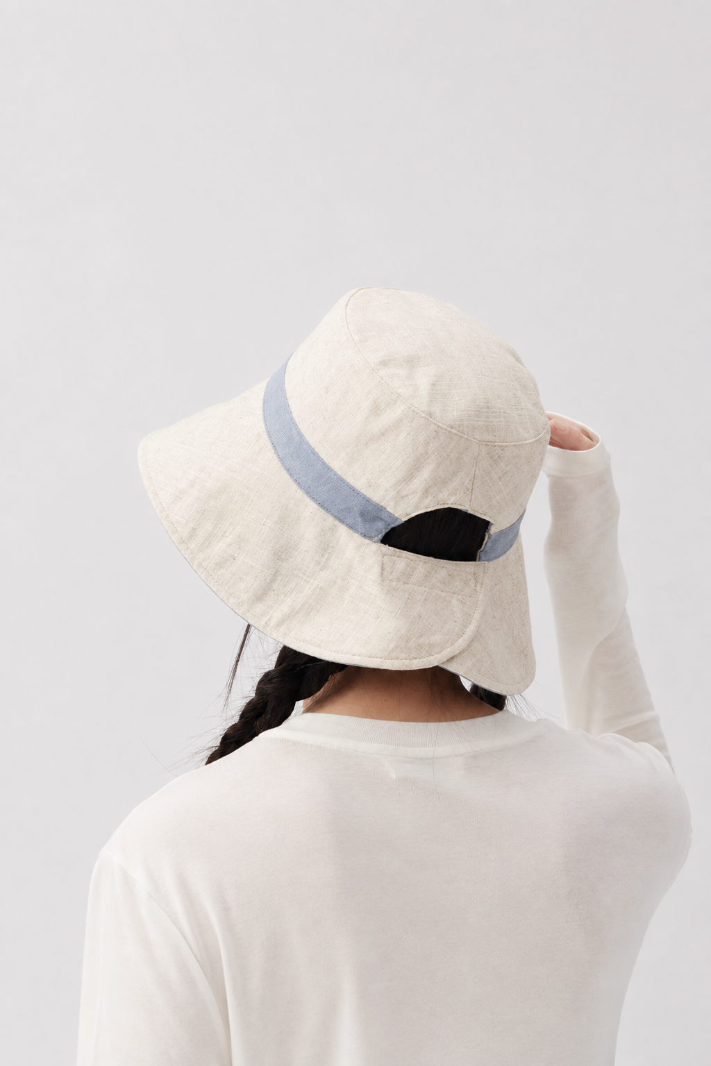 Melba Lane – Tinos light blue reversible bucket sun hat from the back, showing the split brim and adjustable back tab